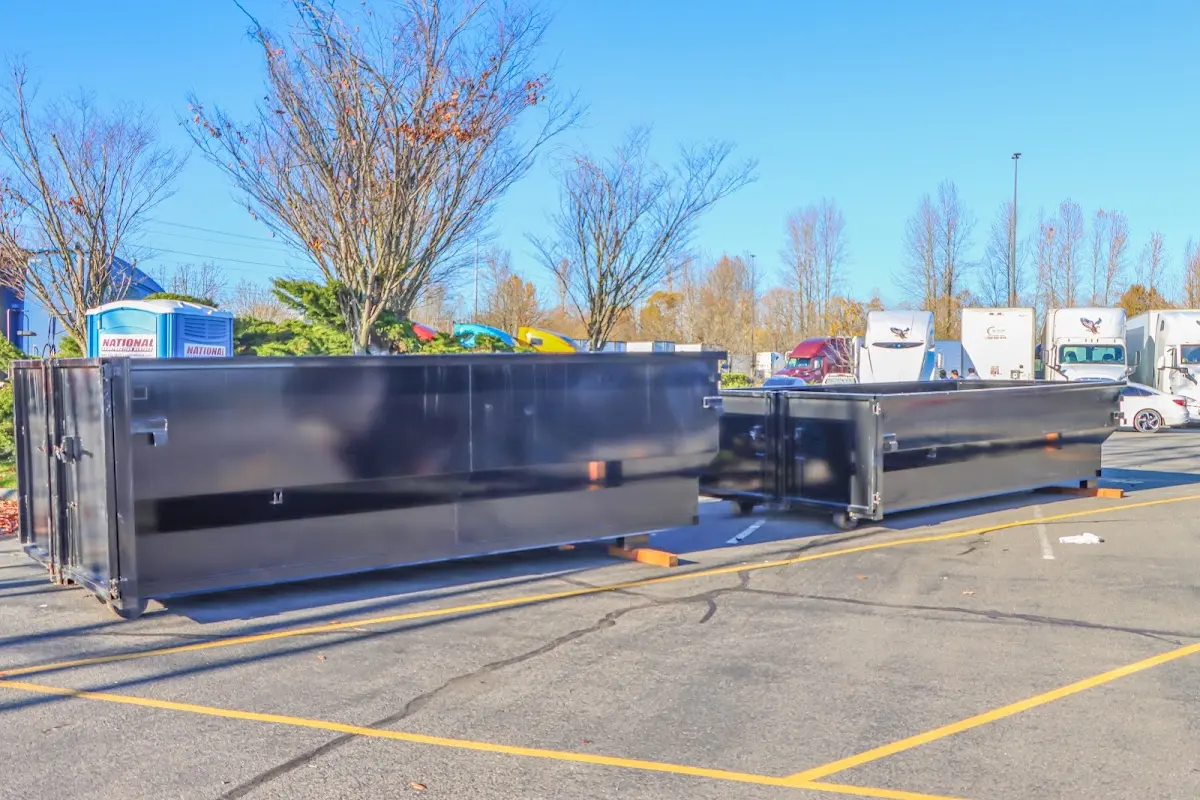 Professional dumpster rental service with roll-off container on residential driveway in New Ulm